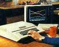Apple II series computer showing person working with it in kitchen